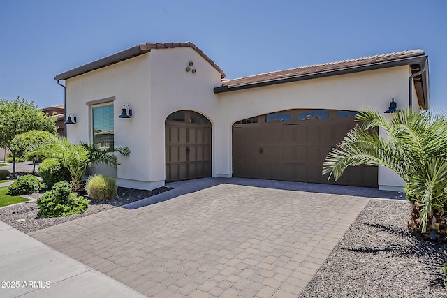199 E Tangerine Path, Queen Creek, AZ 85140 - mediterranean / spanish-style home with a garage, decorative driveway, stucco siding, and a tiled roof