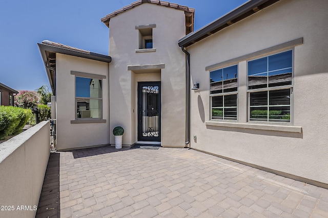 199 E Tangerine Path, Queen Creek, AZ 85140 - view of exterior entry featuring stucco siding and a patio area