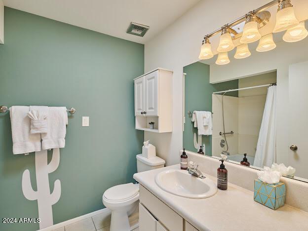 full bathroom with toilet, tile patterned flooring, vanity, and shower / bath combination with curtain