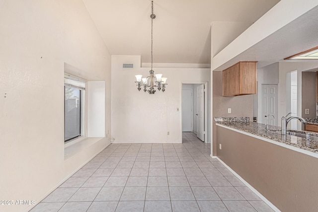 6032 W Grovers Ave, Glendale, AZ 85308 - kitchen with a sink, a chandelier, high vaulted ceiling, light tile patterned flooring, and light stone counters