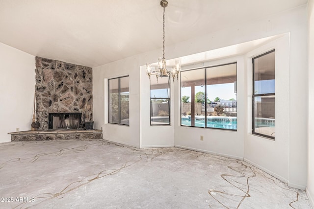 6032 W Grovers Ave, Glendale, AZ 85308 - unfurnished dining area with a chandelier, a fireplace, and concrete floors