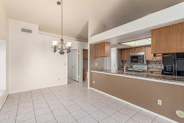 6032 W Grovers Ave, Glendale, AZ 85308 - kitchen featuring black appliances, lofted ceiling, brown cabinets, a chandelier, and light tile patterned floors