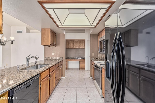 6032 W Grovers Ave, Glendale, AZ 85308 - kitchen with a sink, black appliances, and brown cabinetry