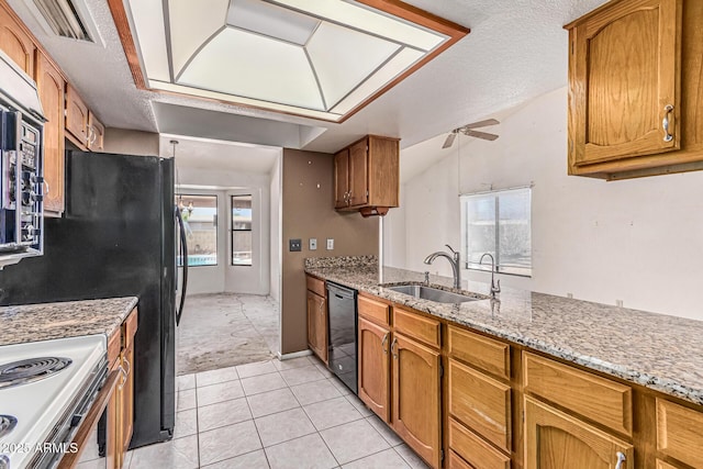 6032 W Grovers Ave, Glendale, AZ 85308 - kitchen with black dishwasher, a sink, a ceiling fan, brown cabinets, and light stone counters