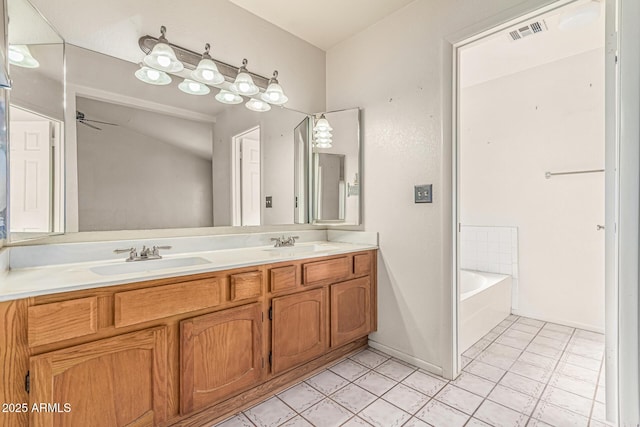 6032 W Grovers Ave, Glendale, AZ 85308 - full bathroom featuring double vanity, ceiling fan, a tub, and tile patterned flooring