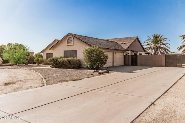 6032 W Grovers Ave, Glendale, AZ 85308 - view of front facade with a garage, concrete driveway, and stucco siding