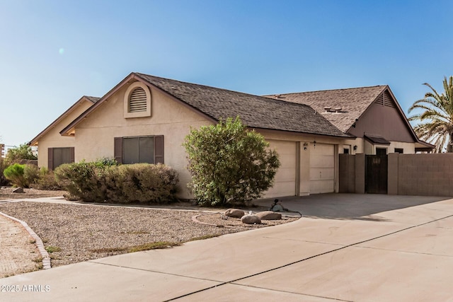 6032 W Grovers Ave, Glendale, AZ 85308 - view of front of property featuring an attached garage, driveway, roof with shingles, and stucco siding