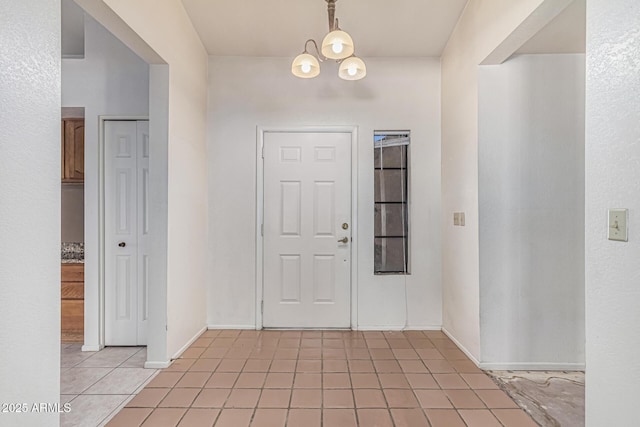 6032 W Grovers Ave, Glendale, AZ 85308 - foyer entrance featuring light tile patterned floors, a chandelier, and baseboards
