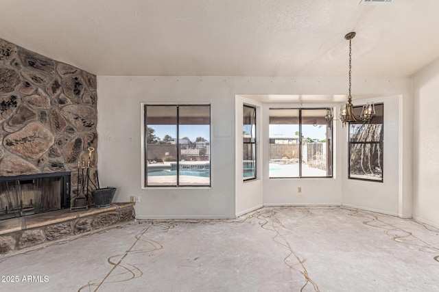 6032 W Grovers Ave, Glendale, AZ 85308 - unfurnished living room with a chandelier and a fireplace