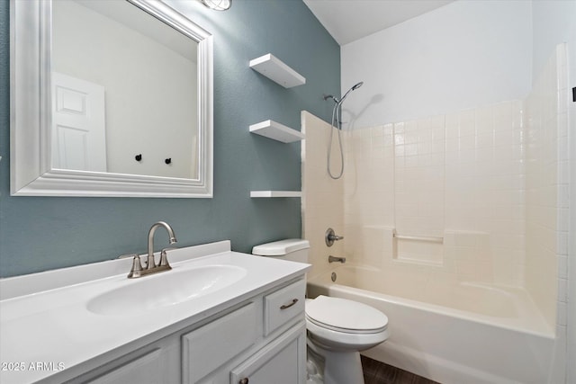 bathroom featuring vanity, bathing tub / shower combination, toilet, and wood finished floors