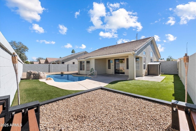 back of house featuring a fenced in pool, a lawn, stucco siding, a fenced backyard, and a patio area