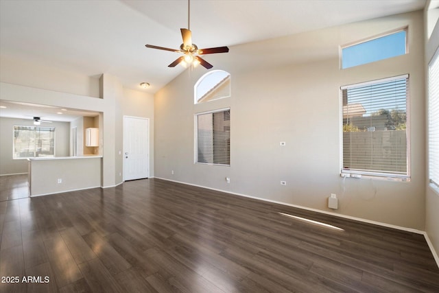 unfurnished living room with dark wood-type flooring, a ceiling fan, and high vaulted ceiling