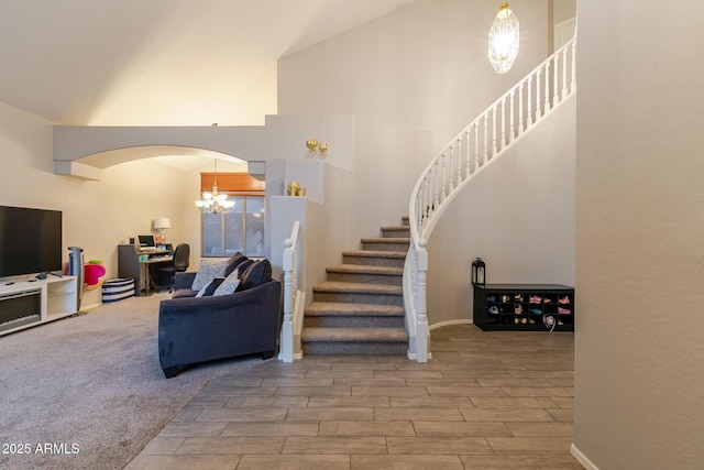 288 W Los Alamos St, Gilbert, AZ 85233 - stairway featuring a chandelier, arched walkways, wood tiled floors, and high vaulted ceiling