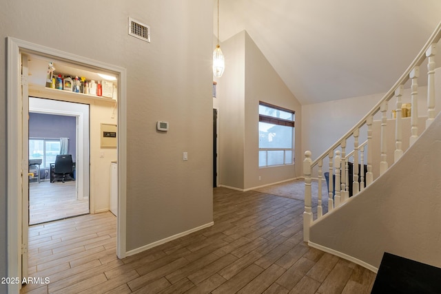288 W Los Alamos St, Gilbert, AZ 85233 - foyer featuring high vaulted ceiling, healthy amount of natural light, wood finished floors, and stairway