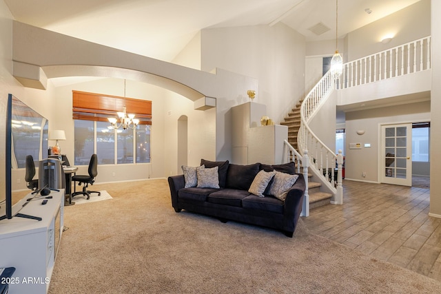 288 W Los Alamos St, Gilbert, AZ 85233 - living room with a chandelier, arched walkways, stairway, baseboards, and high vaulted ceiling