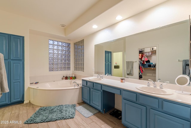 288 W Los Alamos St, Gilbert, AZ 85233 - full bathroom featuring a garden tub, double vanity, wood finished floors, recessed lighting, and a spacious closet