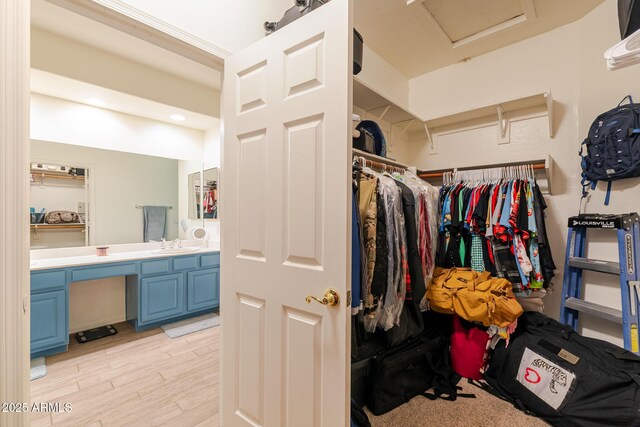 288 W Los Alamos St, Gilbert, AZ 85233 - walk in closet featuring attic access, a sink, and light wood-style floors