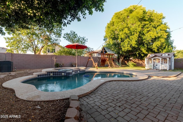 288 W Los Alamos St, Gilbert, AZ 85233 - view of swimming pool with a playground, a fenced backyard, a patio, an outbuilding, and a pool with connected hot tub