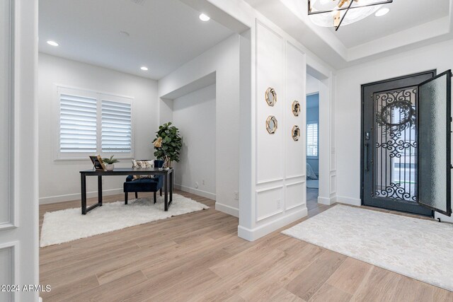 kitchen featuring light hardwood / wood-style flooring, a kitchen island, tasteful backsplash, island range hood, and appliances with stainless steel finishes