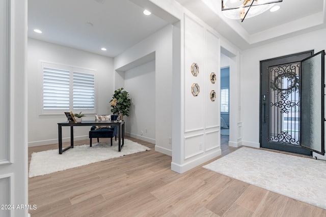 entrance foyer featuring a notable chandelier and light hardwood / wood-style floors