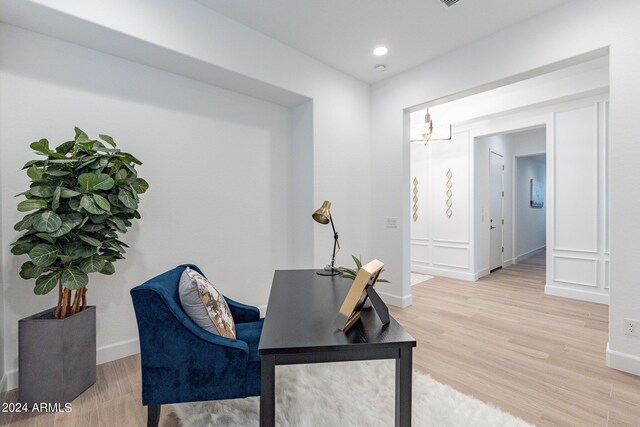 entrance foyer with light hardwood / wood-style flooring and an inviting chandelier