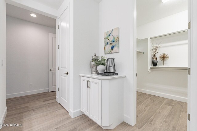 bathroom with hardwood / wood-style flooring and a shower with door