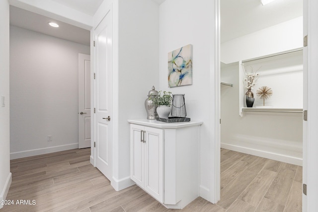 hall with light hardwood / wood-style floors