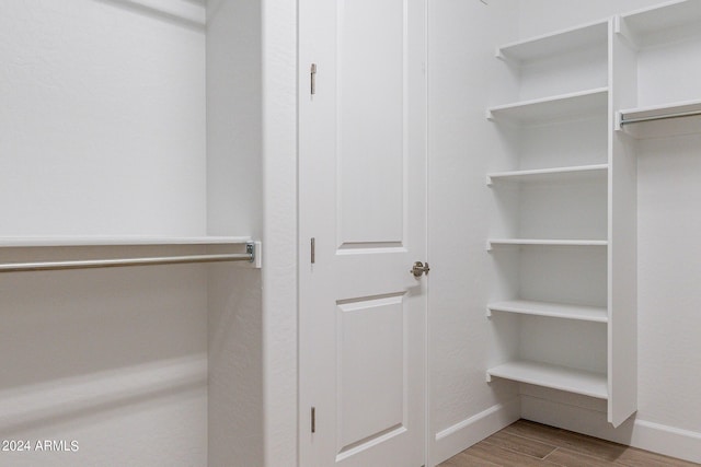 walk in closet featuring light hardwood / wood-style flooring