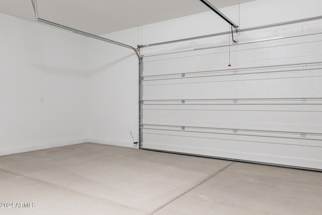 garage featuring a garage door opener and electric water heater