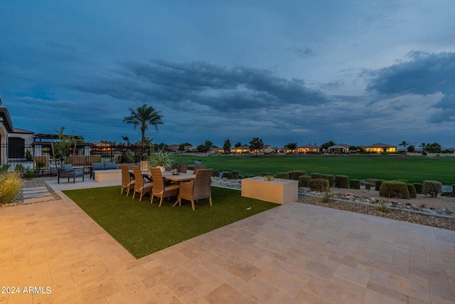 patio terrace at dusk with a lawn