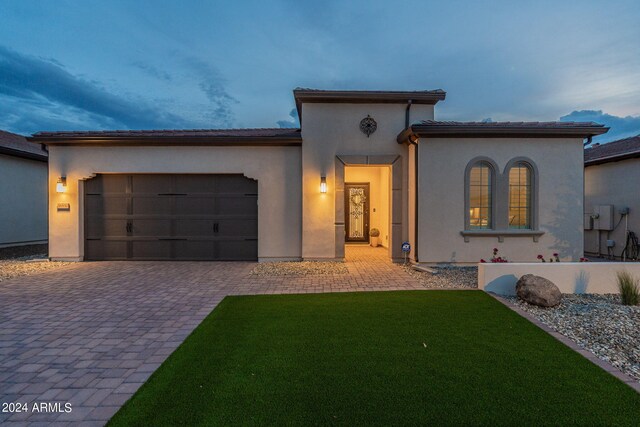 patio at night with a lawn and an outdoor kitchen