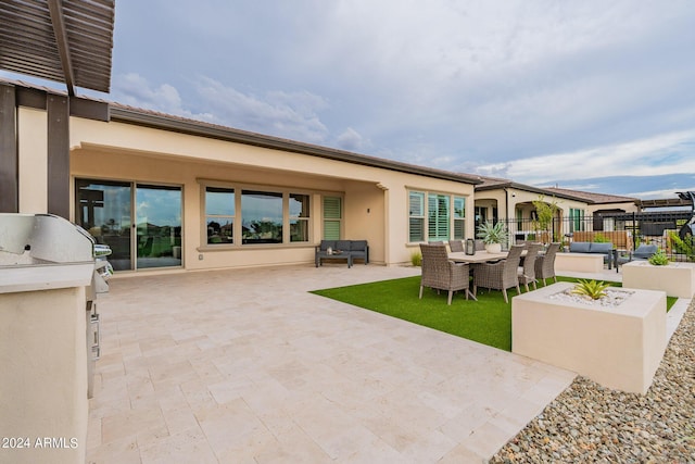 view of patio featuring an outdoor hangout area and exterior kitchen