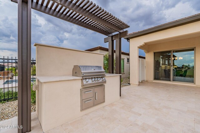 view of patio featuring an outdoor kitchen, area for grilling, and a pergola