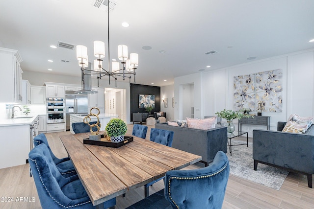 dining room with light hardwood / wood-style flooring and sink