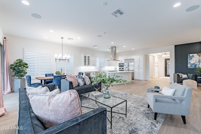 living room featuring light hardwood / wood-style floors and a notable chandelier