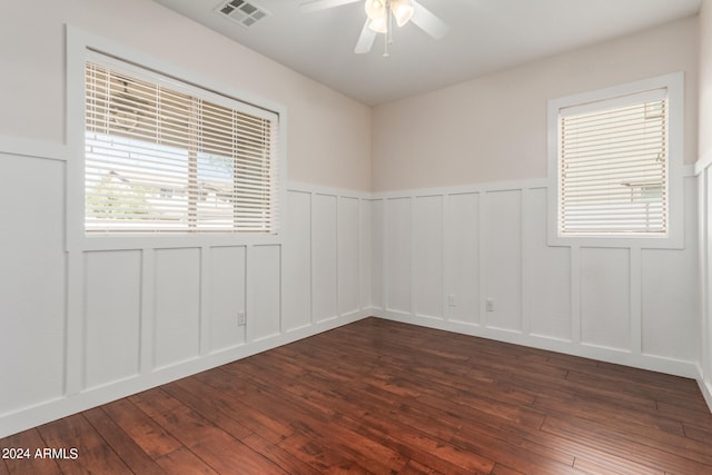 spare room with dark hardwood / wood-style floors and ceiling fan