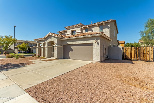 mediterranean / spanish-style home featuring a garage