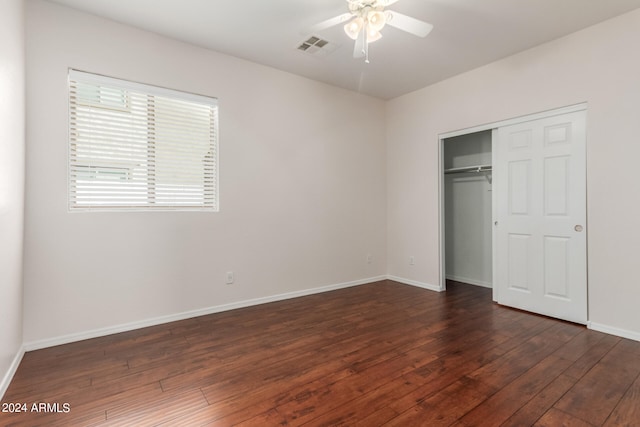 unfurnished bedroom featuring a closet, dark hardwood / wood-style floors, and ceiling fan