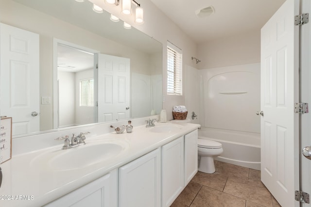 full bathroom featuring shower / bathing tub combination, vanity, a wealth of natural light, and tile patterned floors