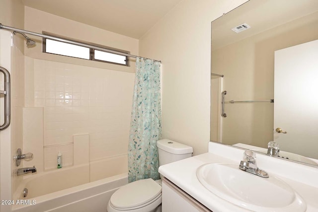 full bathroom featuring shower / bath combination with curtain, toilet, and vanity