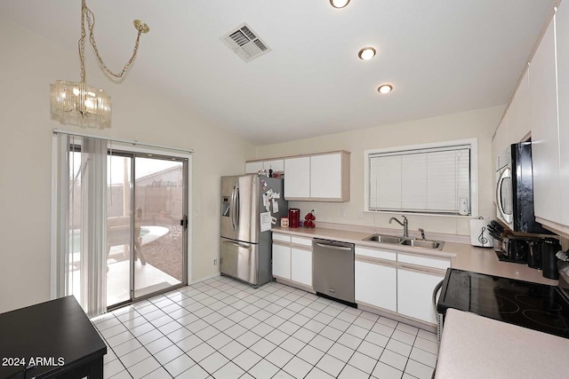 kitchen featuring sink, hanging light fixtures, stainless steel appliances, lofted ceiling, and white cabinets