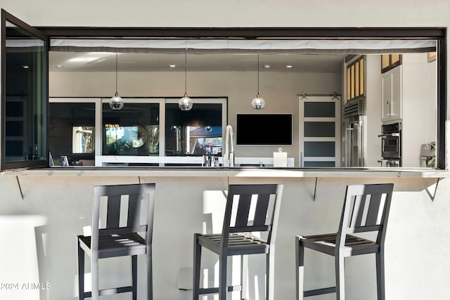 kitchen featuring a kitchen breakfast bar and hanging light fixtures