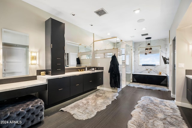 bathroom with hardwood / wood-style floors, vanity, and plus walk in shower