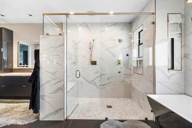 bathroom featuring vanity and separate shower and tub