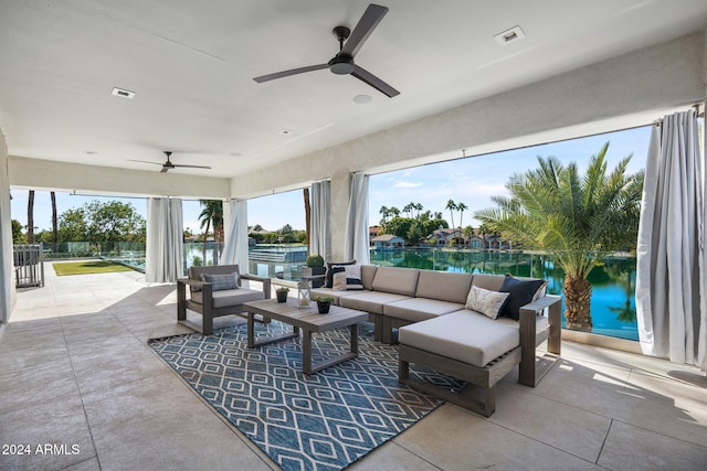 view of patio / terrace featuring an outdoor hangout area, a water view, and ceiling fan