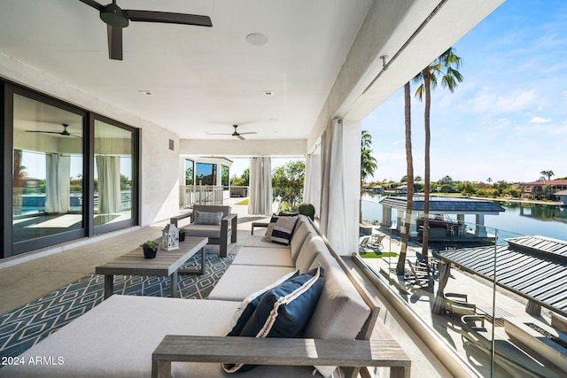 exterior space featuring outdoor lounge area, ceiling fan, a water view, and a balcony