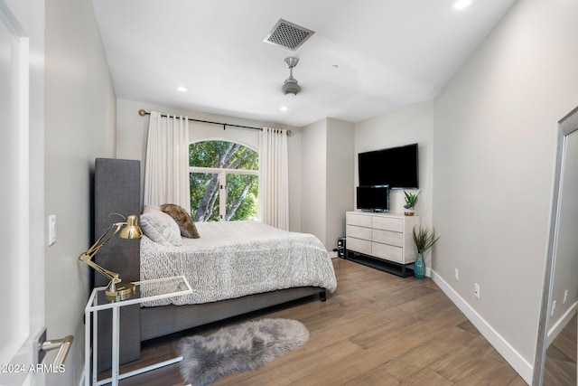 bedroom with wood-type flooring