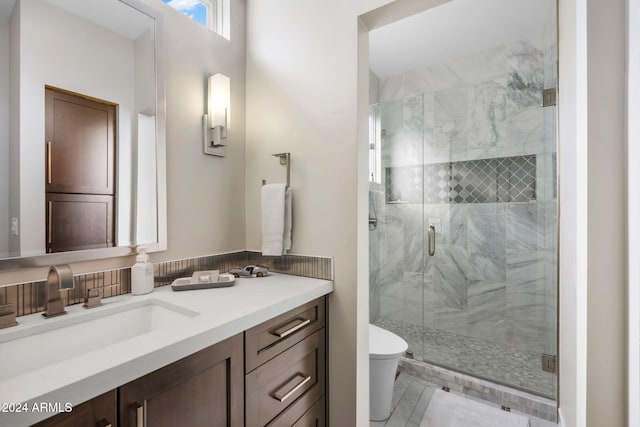 bathroom with tile patterned flooring, vanity, toilet, and a shower with shower door