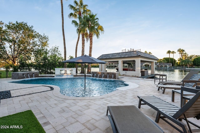 view of pool with pool water feature, a gazebo, a patio, and an in ground hot tub