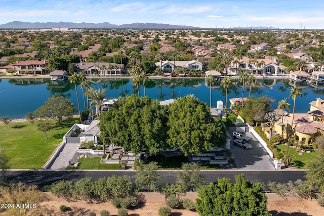 birds eye view of property with a water and mountain view